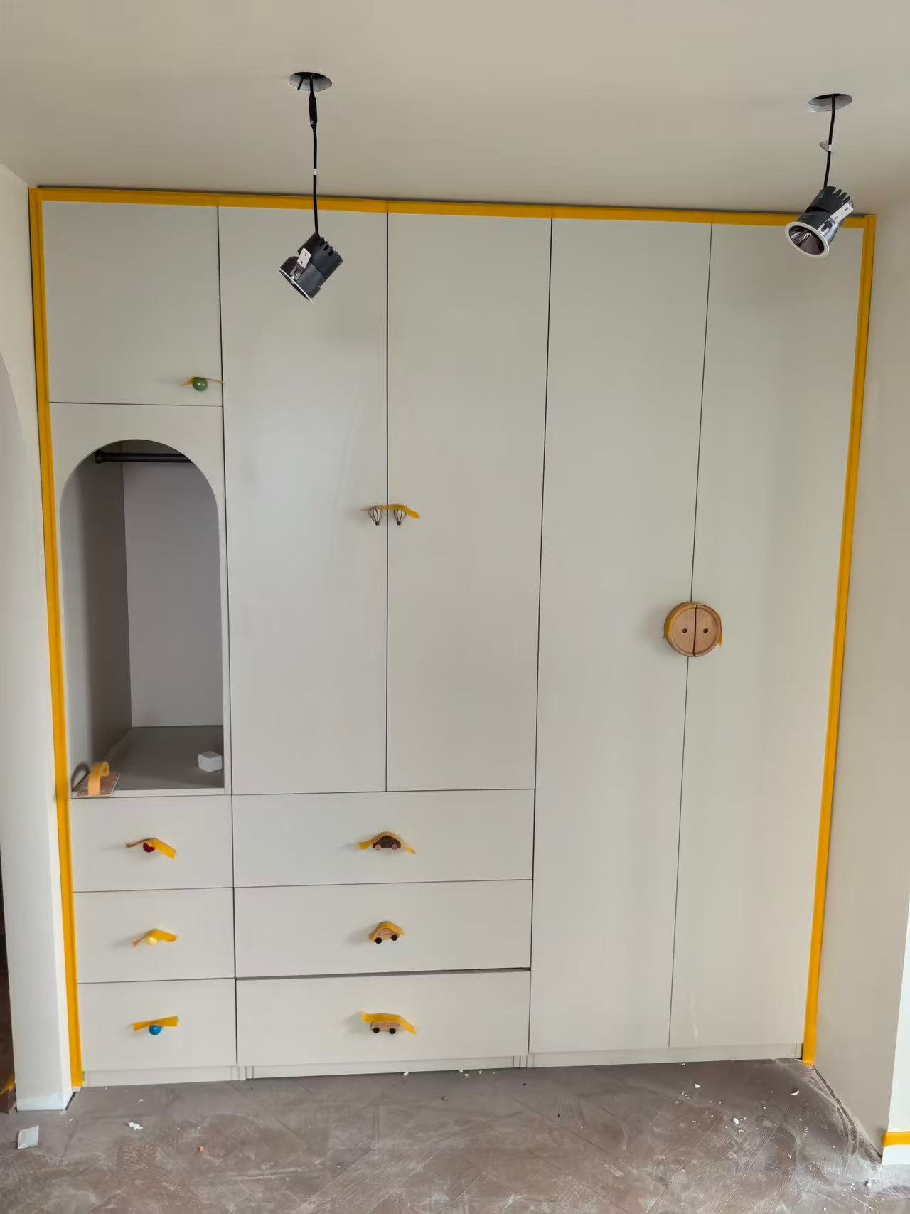 Cream full-height wardrobe with arched display design