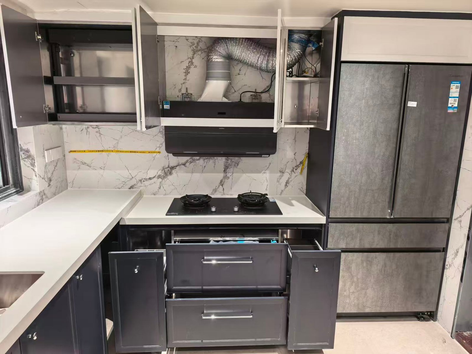 Hob range hood and fridge embedded in kitchen cabinets