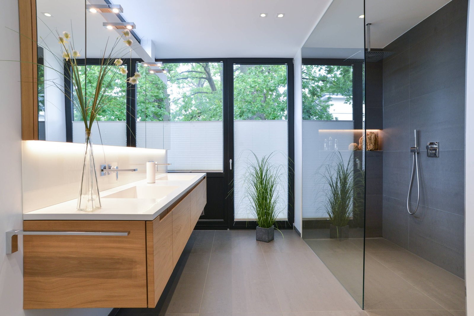 Master ensuite with large-format stone-look tiles and full-height mirror wall