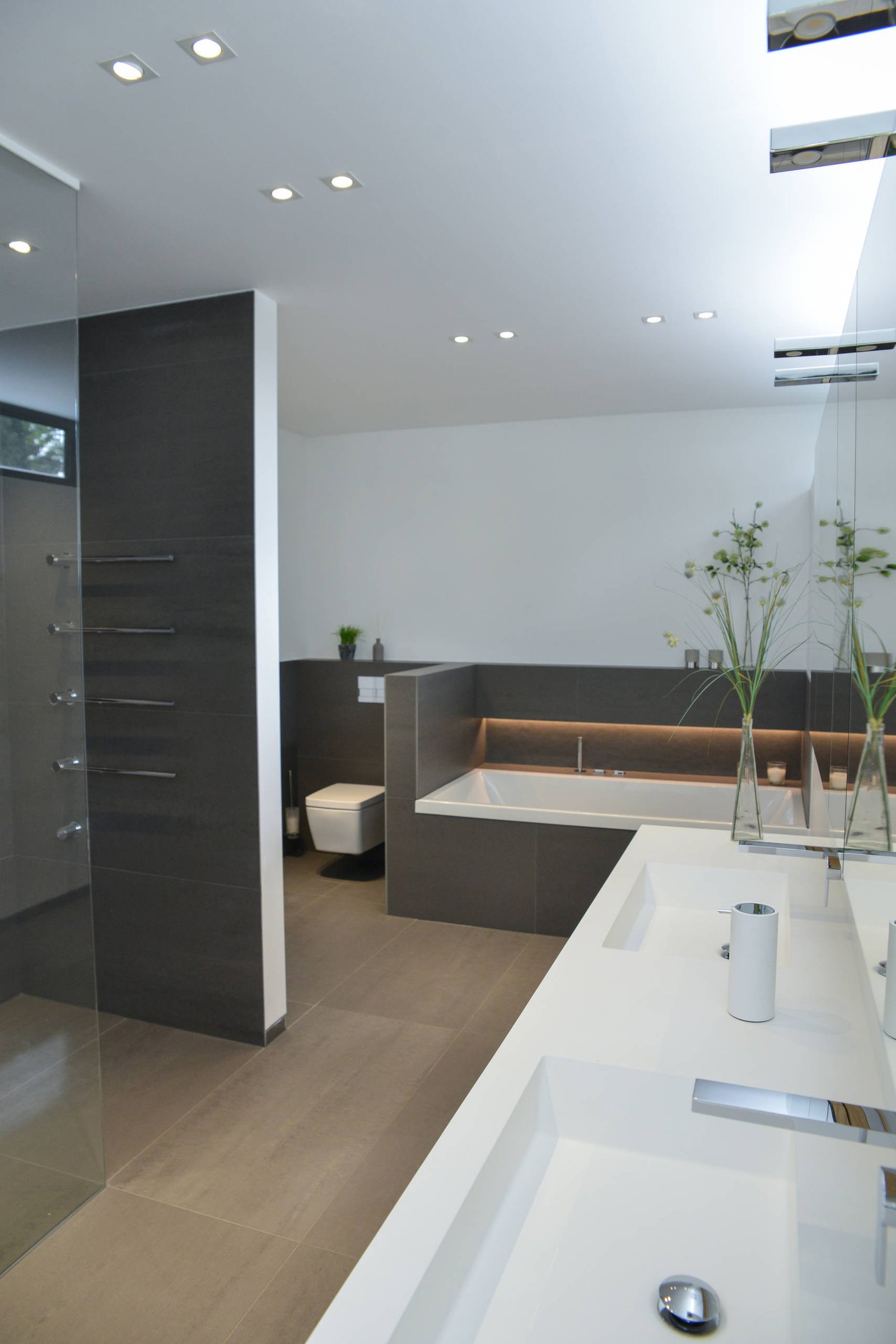 Freestanding tub setting with vanity cabinetry in warm neutrals