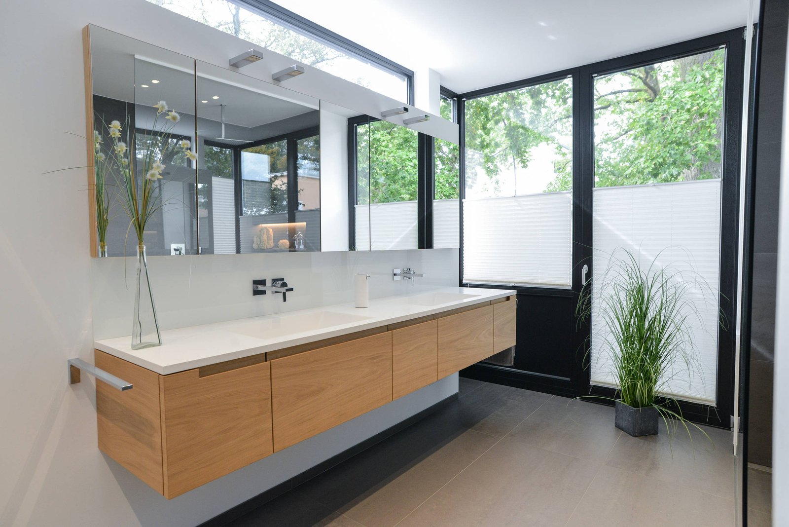 Marble-look bathroom with brushed brass fixtures and custom cabinetry